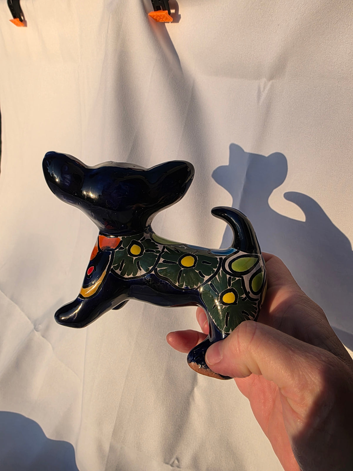 Close-up of hand-painted Talavera patterns on mini ceramic chihuahua