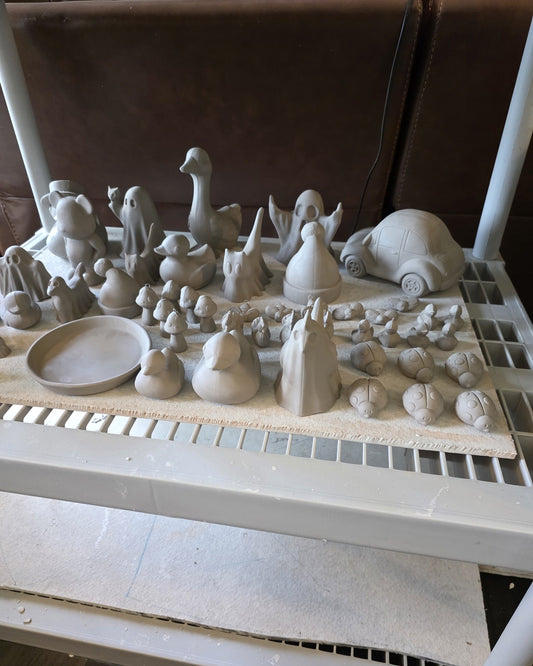 pink pearl studio drying shelf with desk goose ghosts and other greenware ceramics