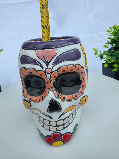 Decorative skull mask with colorful designs on a white background