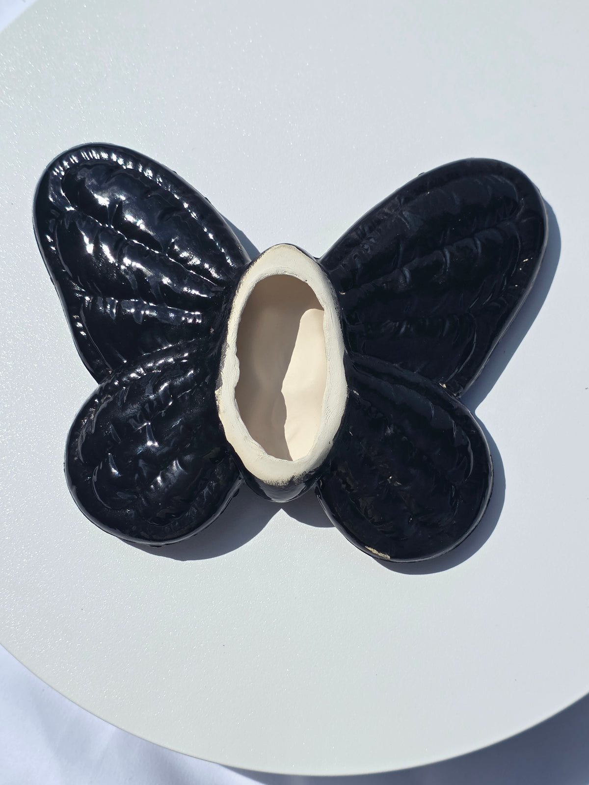 Black butterfly-shaped object on a white background