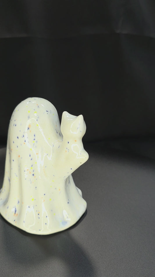 GHOST FIGURINE ROTATING ON A TABLE