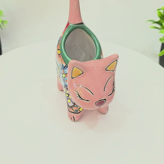 Pink hand-painted Talavera ceramic cat planter by Pottery Pirate, 6 inches tall, featured on a white tabletop turntable