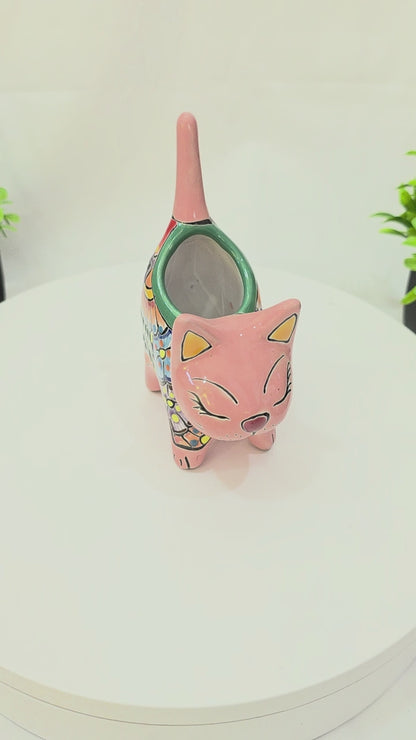 Pink hand-painted Talavera ceramic cat planter by Pottery Pirate, 6 inches tall, featured on a white tabletop turntable