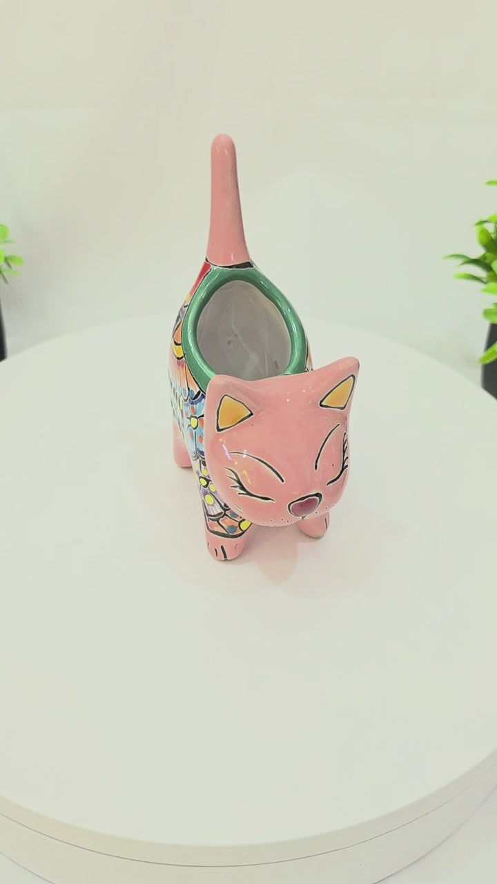 Pink hand-painted Talavera ceramic cat planter by Pottery Pirate, 6 inches tall, featured on a white tabletop turntable