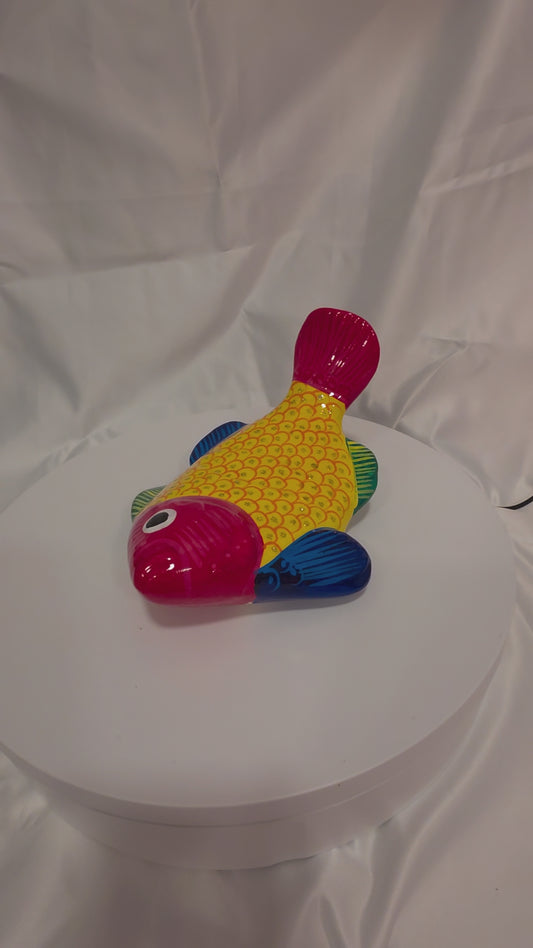 yellow blue orange and red painted fish on a turntable