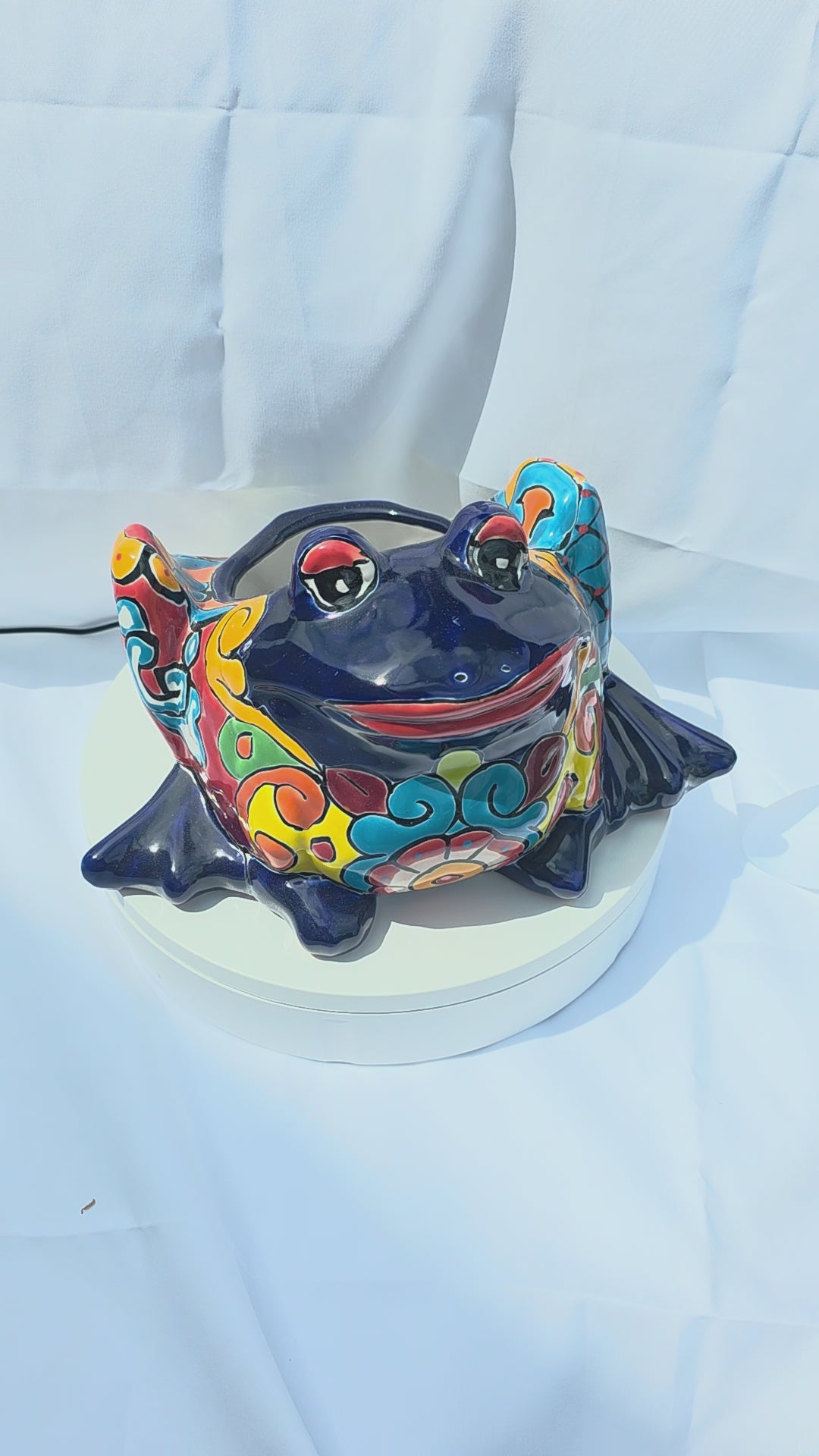  A bright blue hand-painted Mexican frog planter