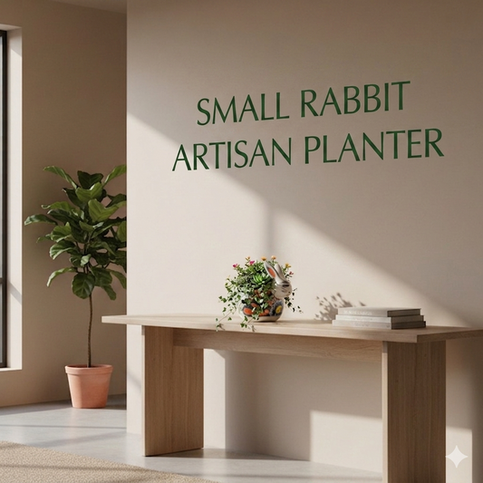 Room interior with a wooden table, plant, and books against a wall with 'Small Rabbit Artisan Planter' text.